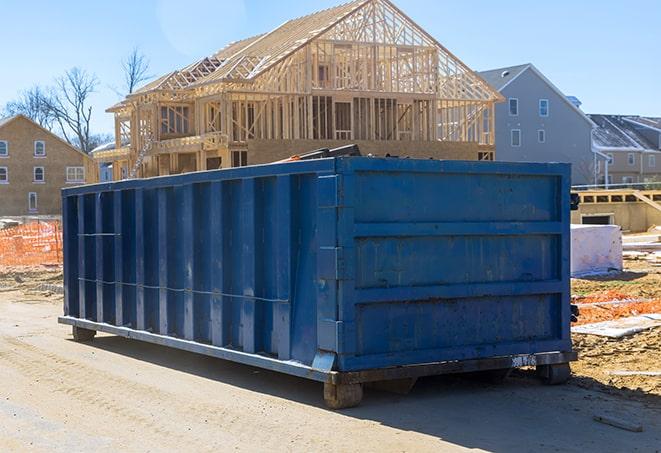 a garbage truck lifting a residential dumpster in a suburban cul-de-sac